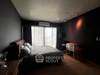 Spacious bedroom with modern decor and city view, featuring a cozy bed and stylish furniture.