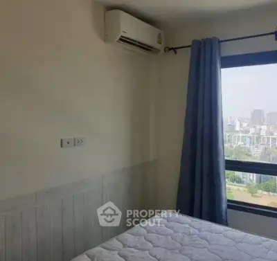 Cozy bedroom with city view and air conditioning