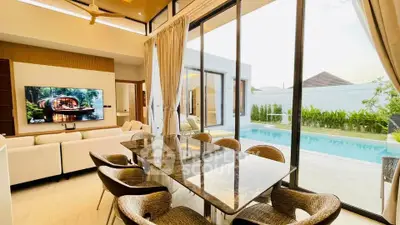 Luxurious open-plan living room with pool view and elegant dining area