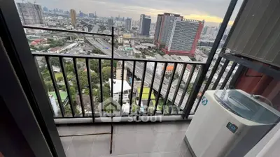 High-rise balcony with city view and washing machine
