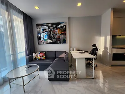 Modern living room with sleek furniture and stylish decor, featuring a cozy sectional sofa and a contemporary desk setup.