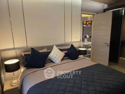Modern bedroom with stylish decor and ambient lighting, featuring a cozy bed and elegant furnishings.