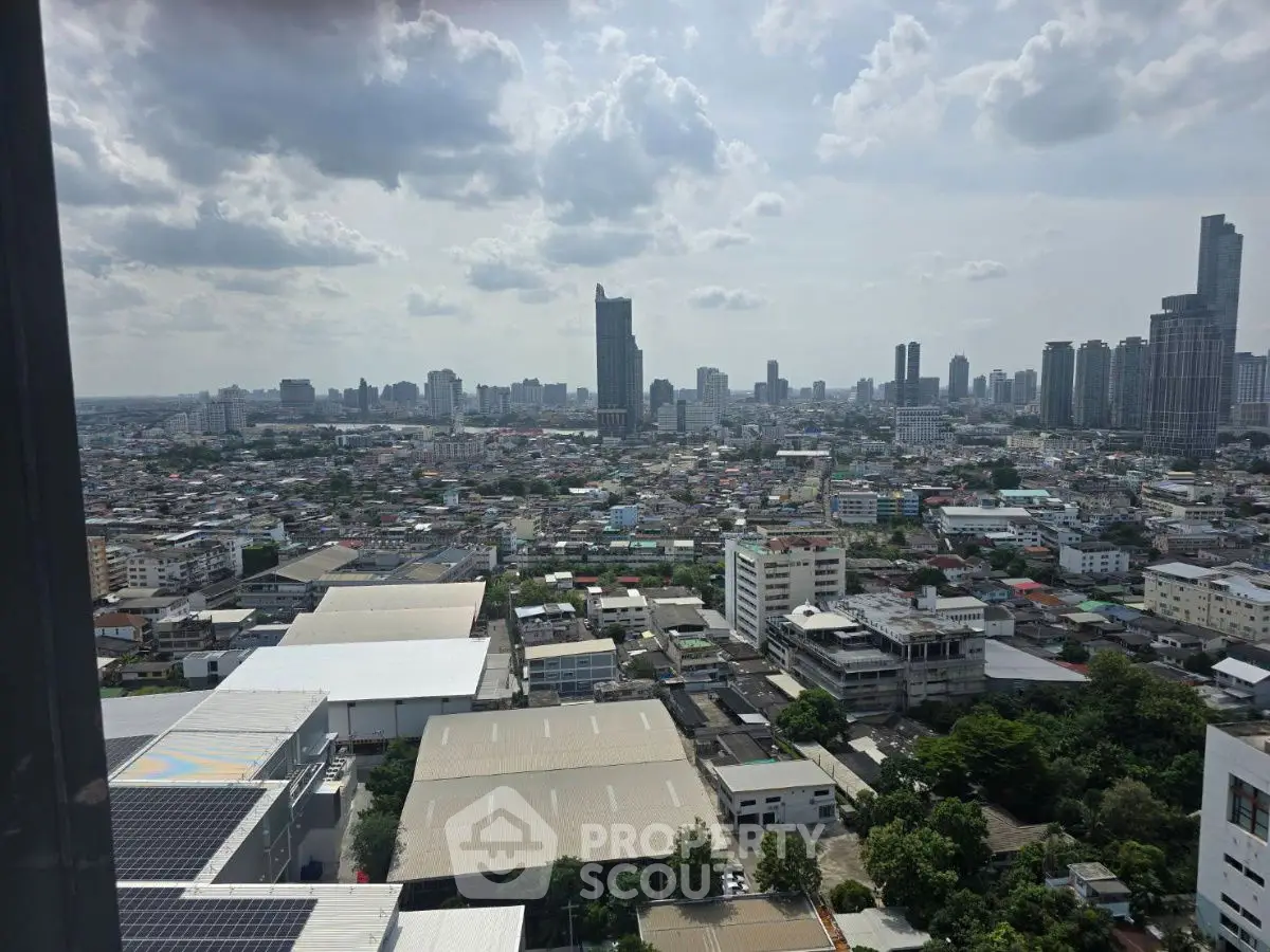 Stunning cityscape view from high-rise building showcasing urban skyline and residential areas.