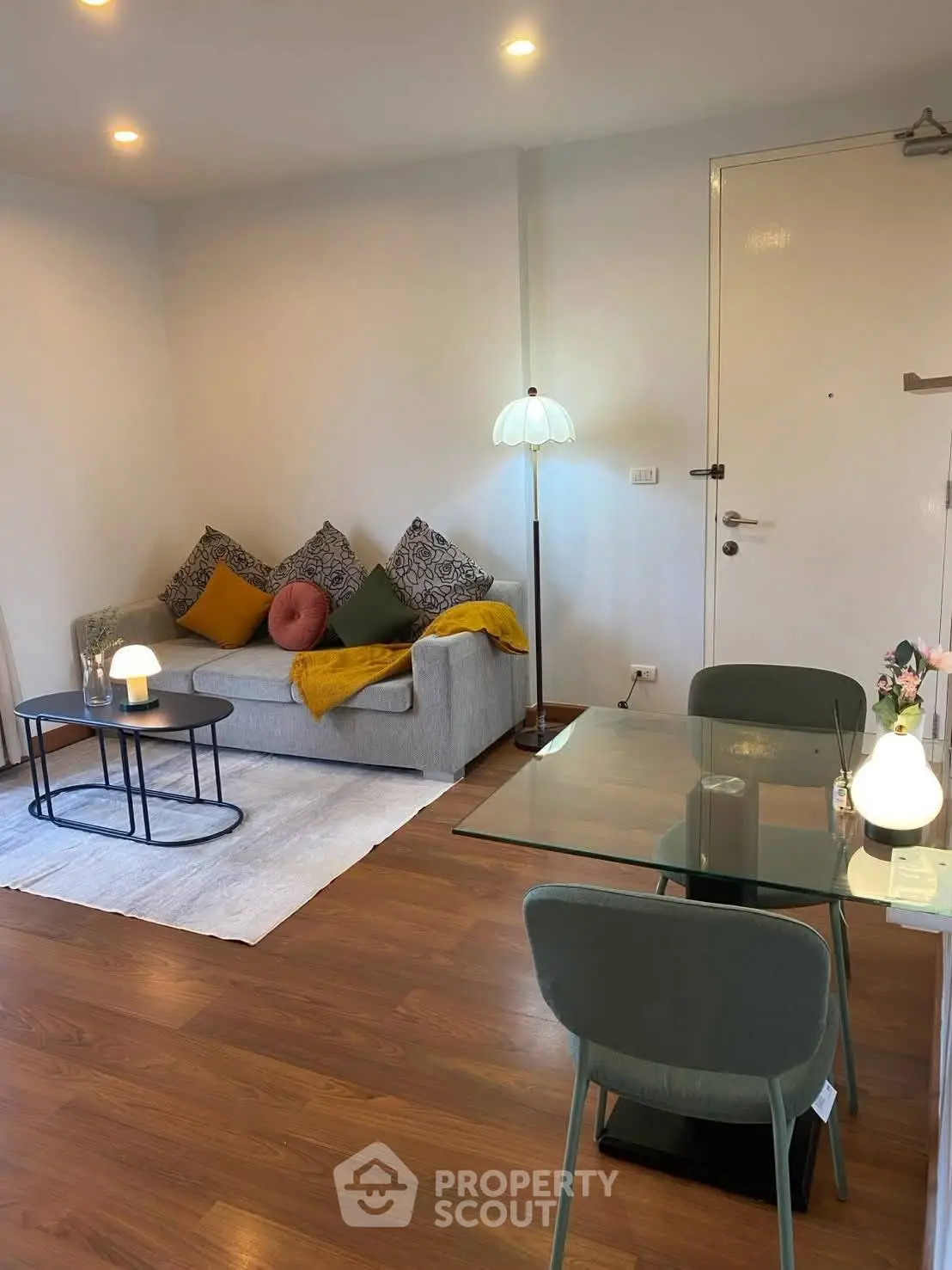 Chic modern living room with cozy sofa and stylish dining area, perfect for urban living.
