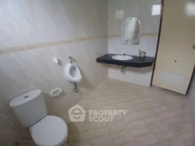 Spacious bathroom with modern fixtures and elegant tile flooring.