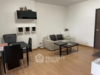 Modern living room with sleek furniture and wooden flooring, ideal for stylish urban living.