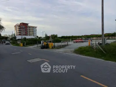 Scenic view of urban road with residential building and parking area