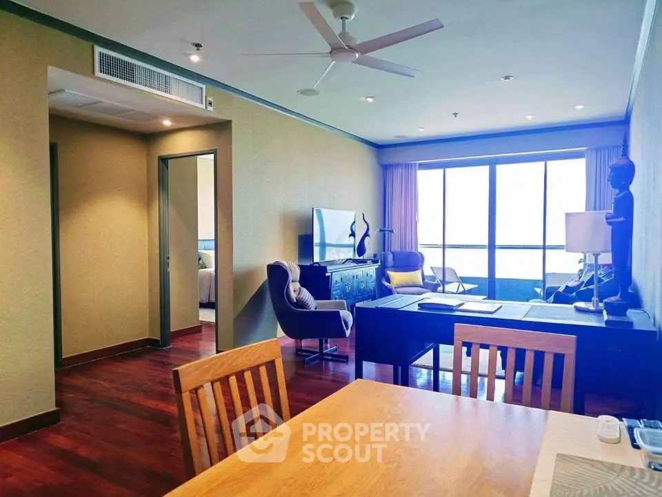 Spacious living room with modern decor and large windows offering a stunning view.