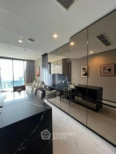 Modern living room with sleek black marble accents and large windows offering city views.
