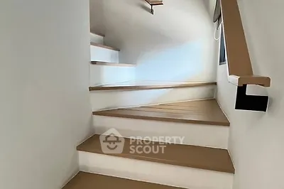 Modern staircase with sleek wooden steps and minimalist design