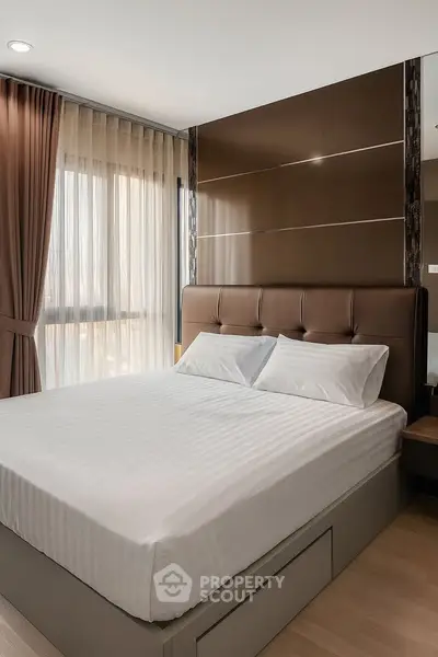 Modern bedroom with elegant decor and large window for natural light