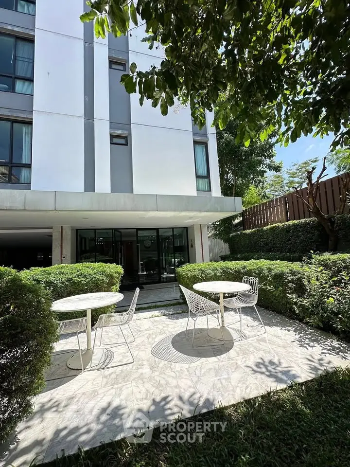 Charming garden patio with modern seating at a stylish apartment building