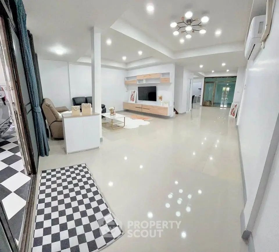 Spacious modern living room with sleek design and ample natural light.