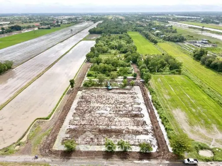 Expansive aerial view of lush green farmland ready for development.