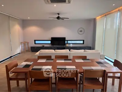 Spacious modern living room with elegant dining area and stylish decor, perfect for entertaining guests.