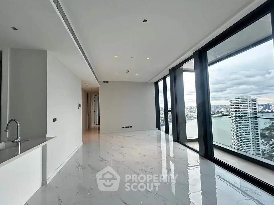 Luxurious corner unit with stunning river view and expansive windows in modern high-rise building.