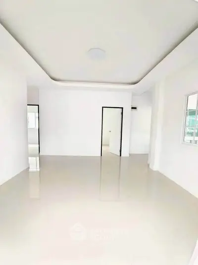 Spacious unfurnished room with glossy floors and modern ceiling design, ideal for customization.