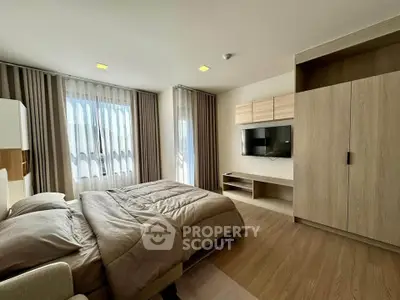 Modern bedroom with large windows and stylish wooden furniture