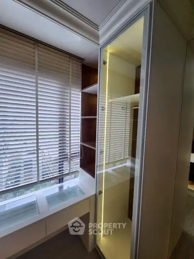 Modern study room with built-in shelves and large window blinds
