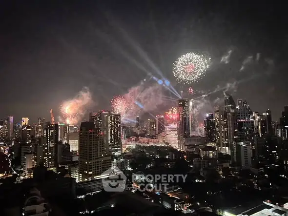Stunning city skyline with vibrant fireworks illuminating the night sky, showcasing urban living at its finest.