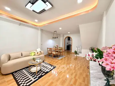 Spacious modern living room with elegant decor and open dining area, perfect for family gatherings.