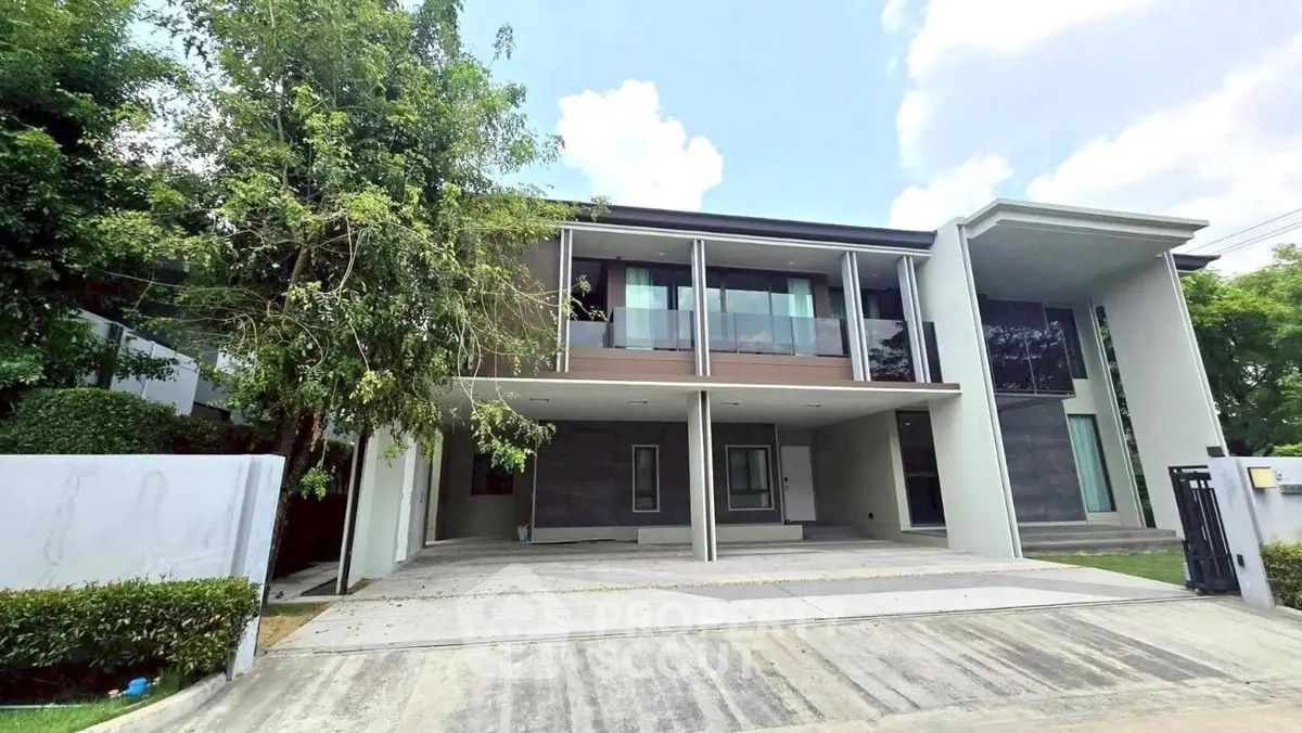 Modern two-story house with sleek design and spacious driveway in a serene neighborhood.