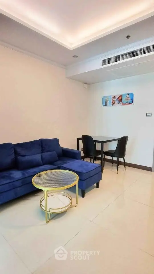Modern living room with blue sofa and stylish decor