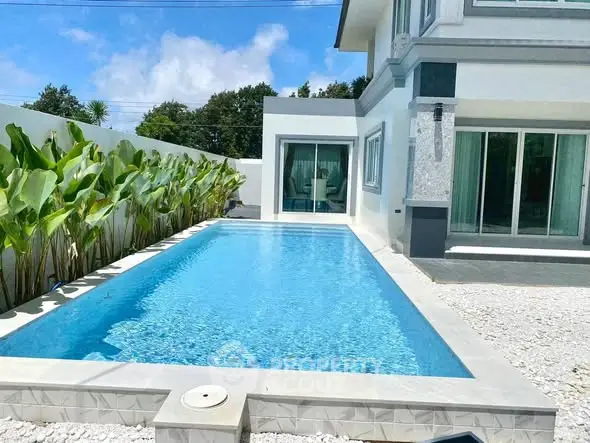 Luxurious modern home with private pool and lush greenery