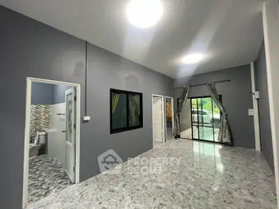 Spacious modern living room with large windows and marble flooring