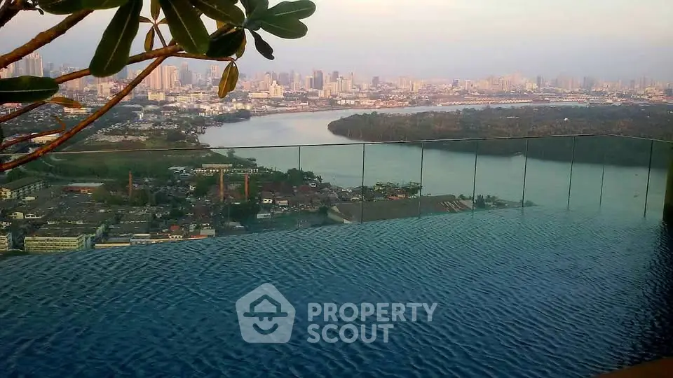 Stunning infinity pool with breathtaking city skyline and river view, perfect for luxury living.