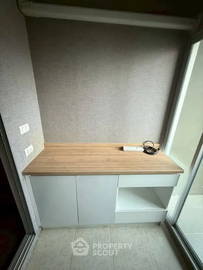 Compact study nook with built-in desk and power outlets, ideal for home office setup.