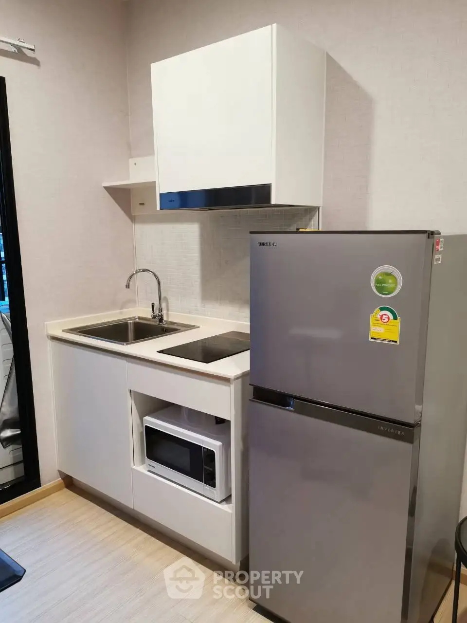 Modern compact kitchen with sleek appliances and efficient layout, perfect for urban living.