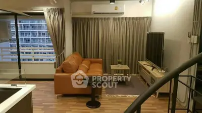 Modern living room with leather sofa and large window in high-rise apartment