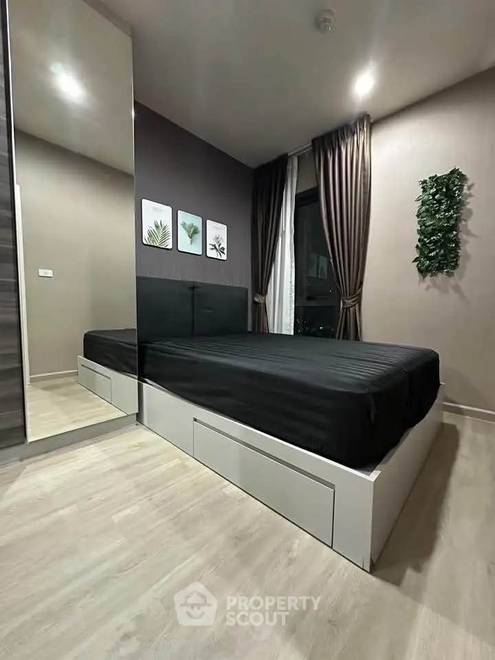 Modern bedroom with sleek design, featuring a large mirror, stylish decor, and cozy ambiance.