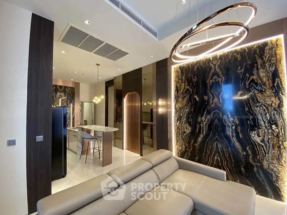 Luxurious modern living room with elegant lighting and marble accent wall