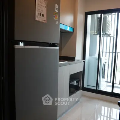 Modern kitchen with sleek appliances and balcony view