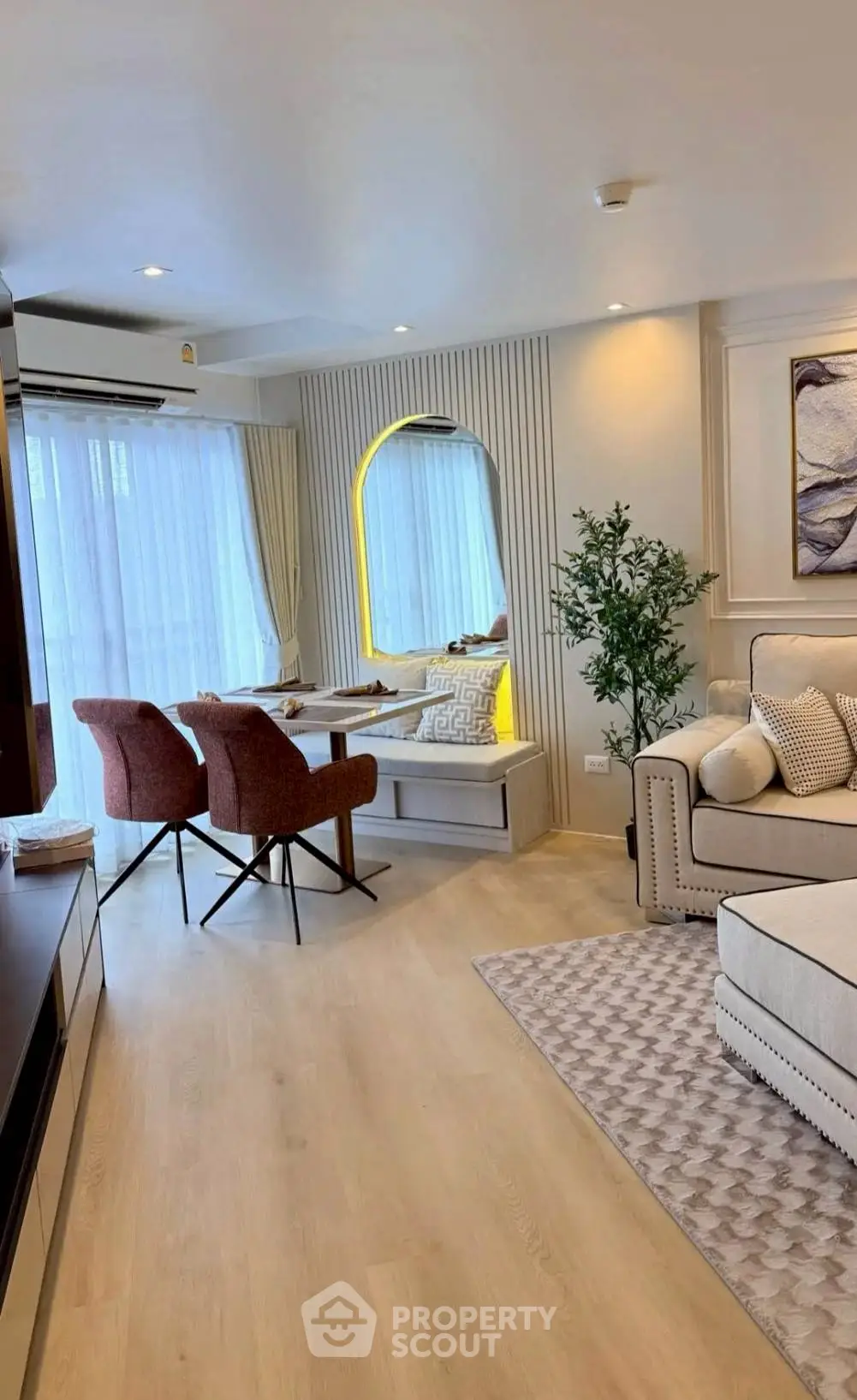 Elegant living room with cozy seating and natural light, perfect for relaxation and entertaining.