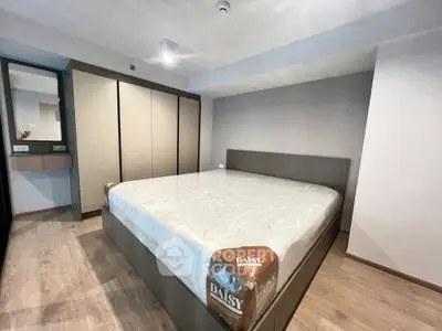Modern bedroom with sleek design and spacious wardrobe in a contemporary apartment.