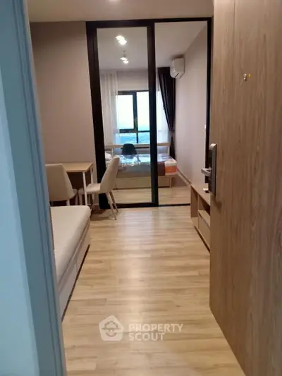 Modern apartment interior with wooden flooring and cozy bedroom view