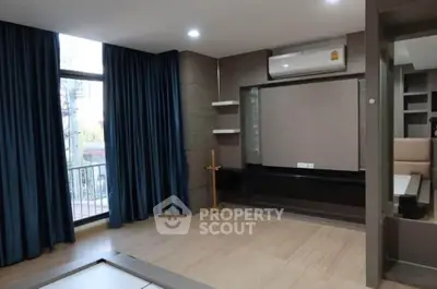 Modern living room with large windows and air conditioning unit