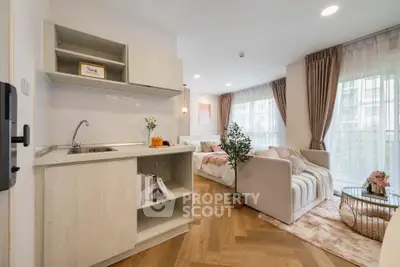 Modern open-layout living room with cozy seating and stylish kitchen area