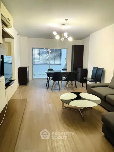 Spacious modern living room with stylish furniture and elegant lighting in a contemporary apartment.