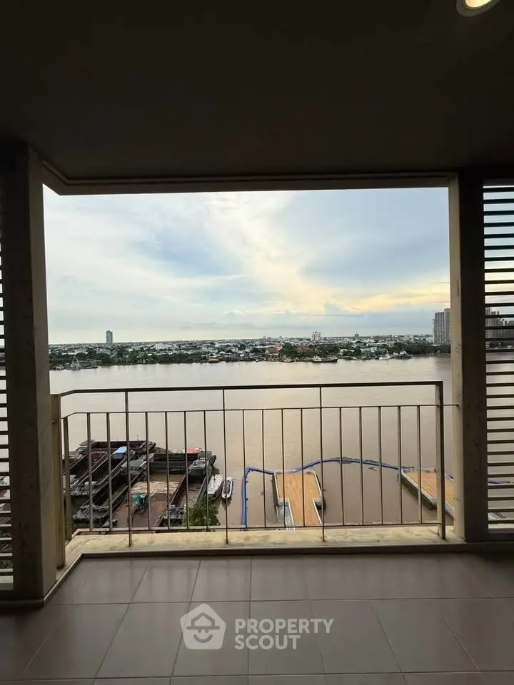 Stunning river view from a spacious balcony in a modern apartment.