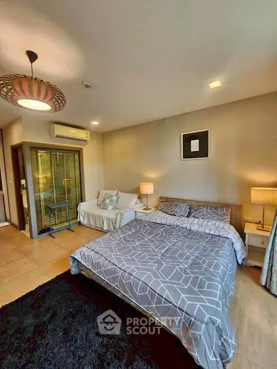 Modern bedroom with stylish decor, cozy bed, and ambient lighting in a contemporary apartment.