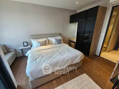 Modern bedroom with stylish decor and cozy ambiance, featuring a comfortable bed and sleek furniture.