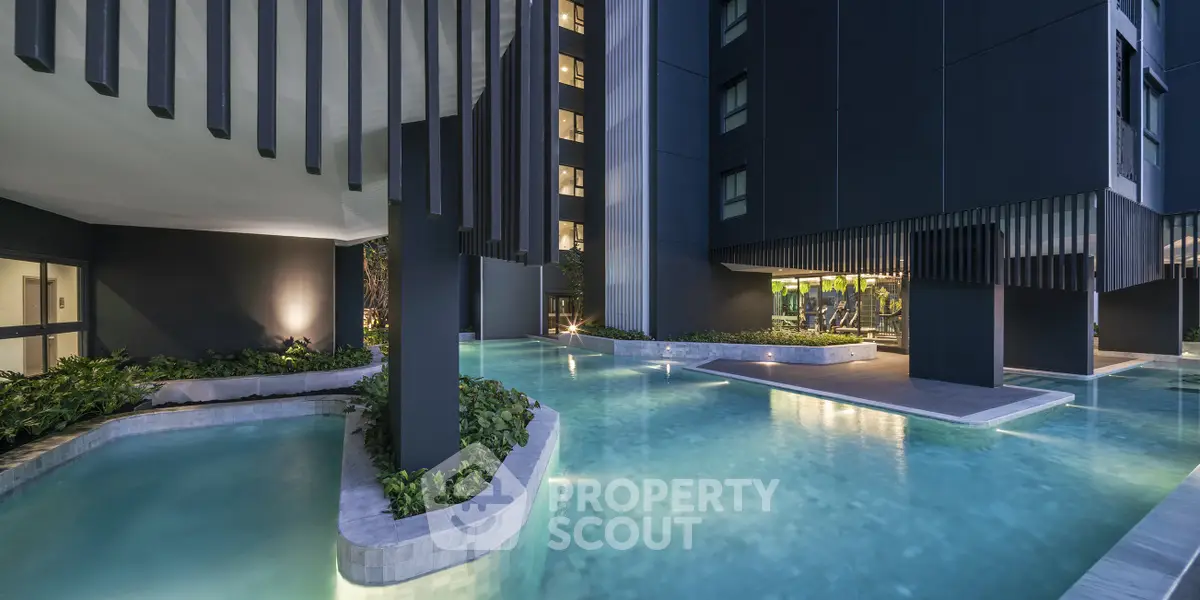 Luxurious modern building with stunning pool and sleek architectural design.