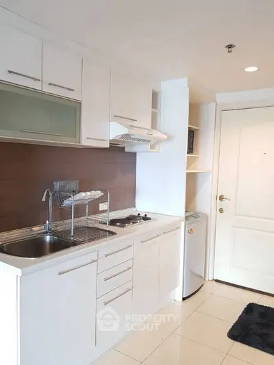 Modern kitchen with sleek white cabinetry and stainless steel appliances