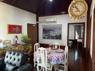 Charming vintage-style living room with elegant dining area and classic decor.