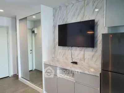 Modern living room with wall-mounted TV and sleek storage cabinets