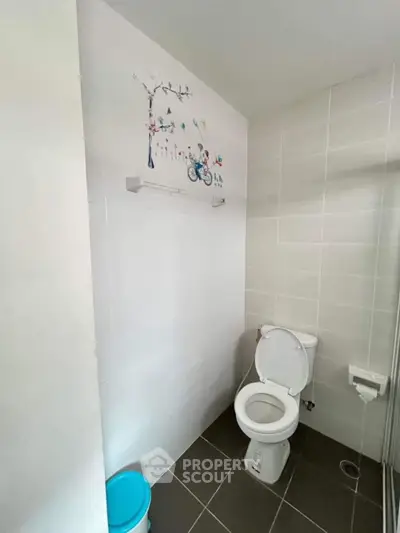 Modern bathroom with wall art and tiled flooring